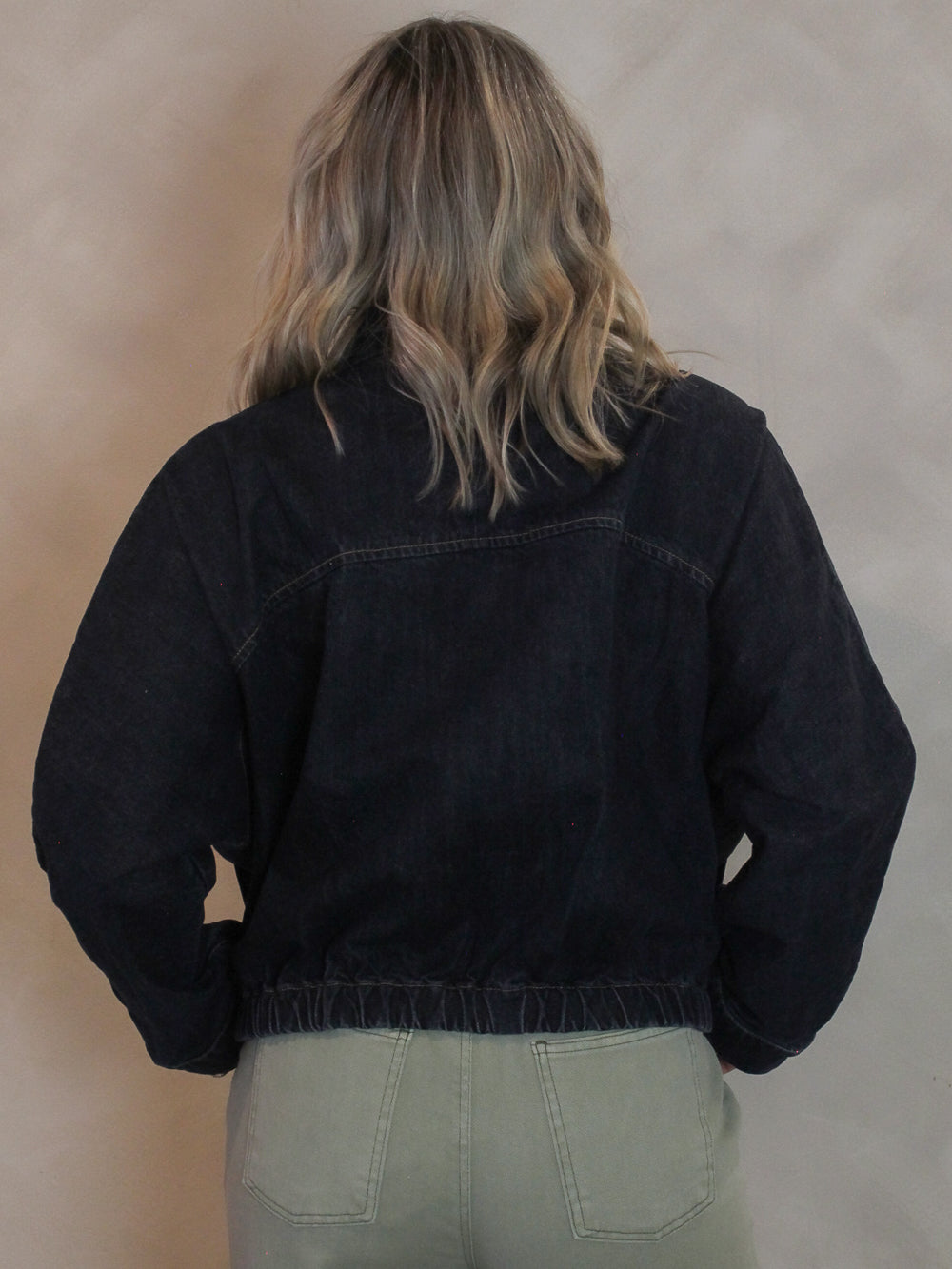 Woman wearing a boxy style denim jacket