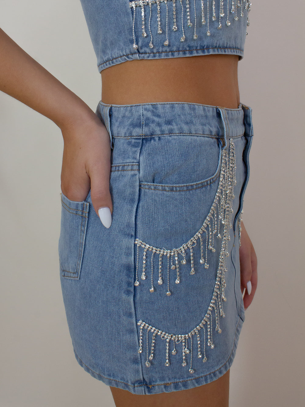 Denim mini skirt with silver rhinestone fringe details 