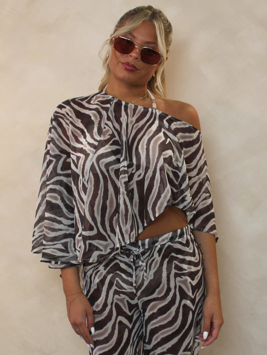 Woman wearing a zebra print, chiffon cape.