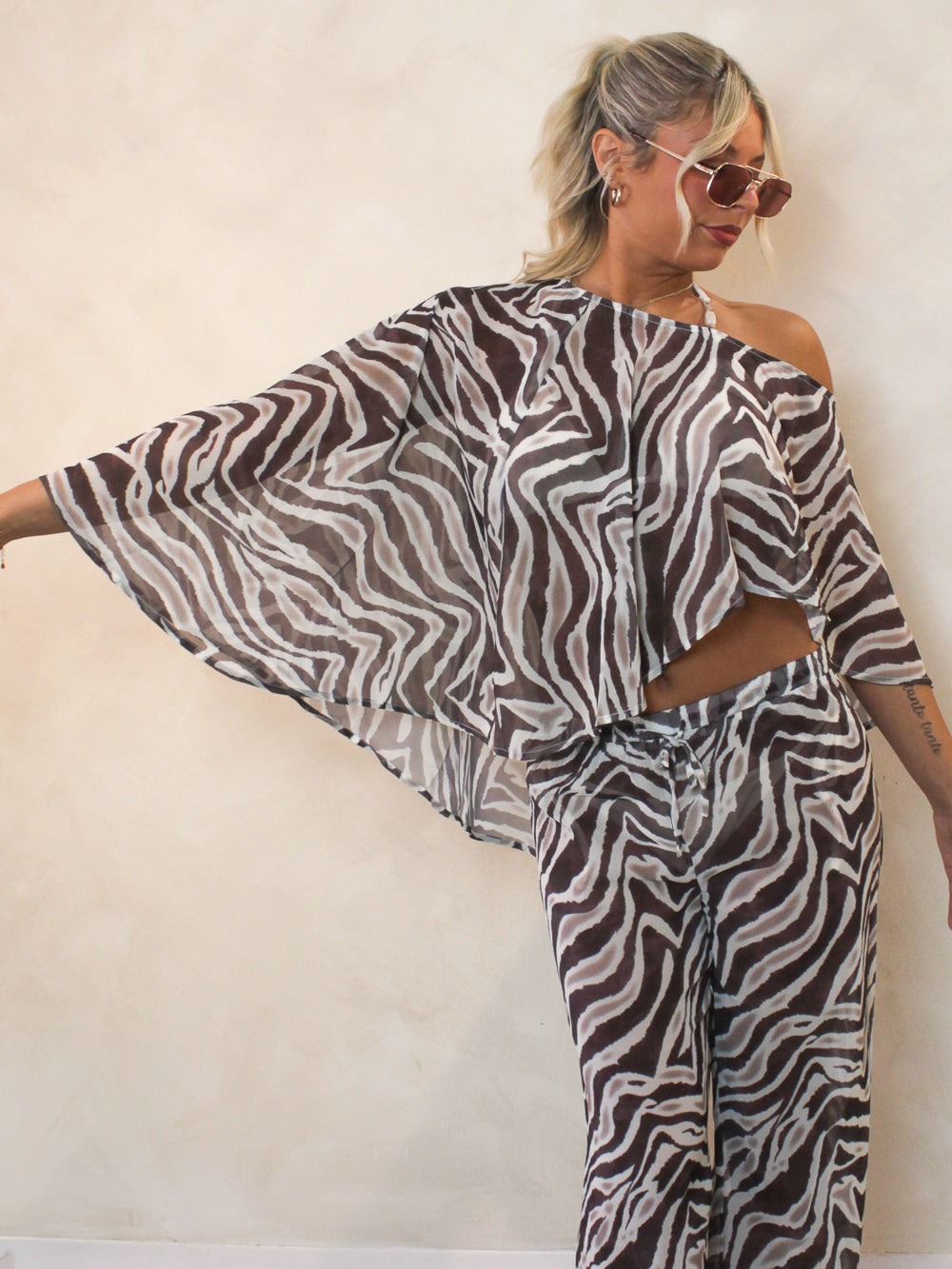 Woman wearing a sheer zebra cover up top