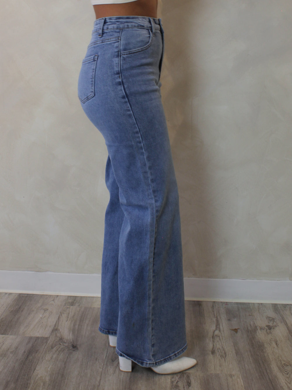 Woman wearing a pair of light blue, wide leg jeans 