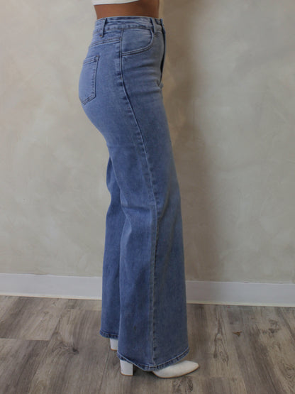 Woman wearing a pair of light blue, wide leg jeans 