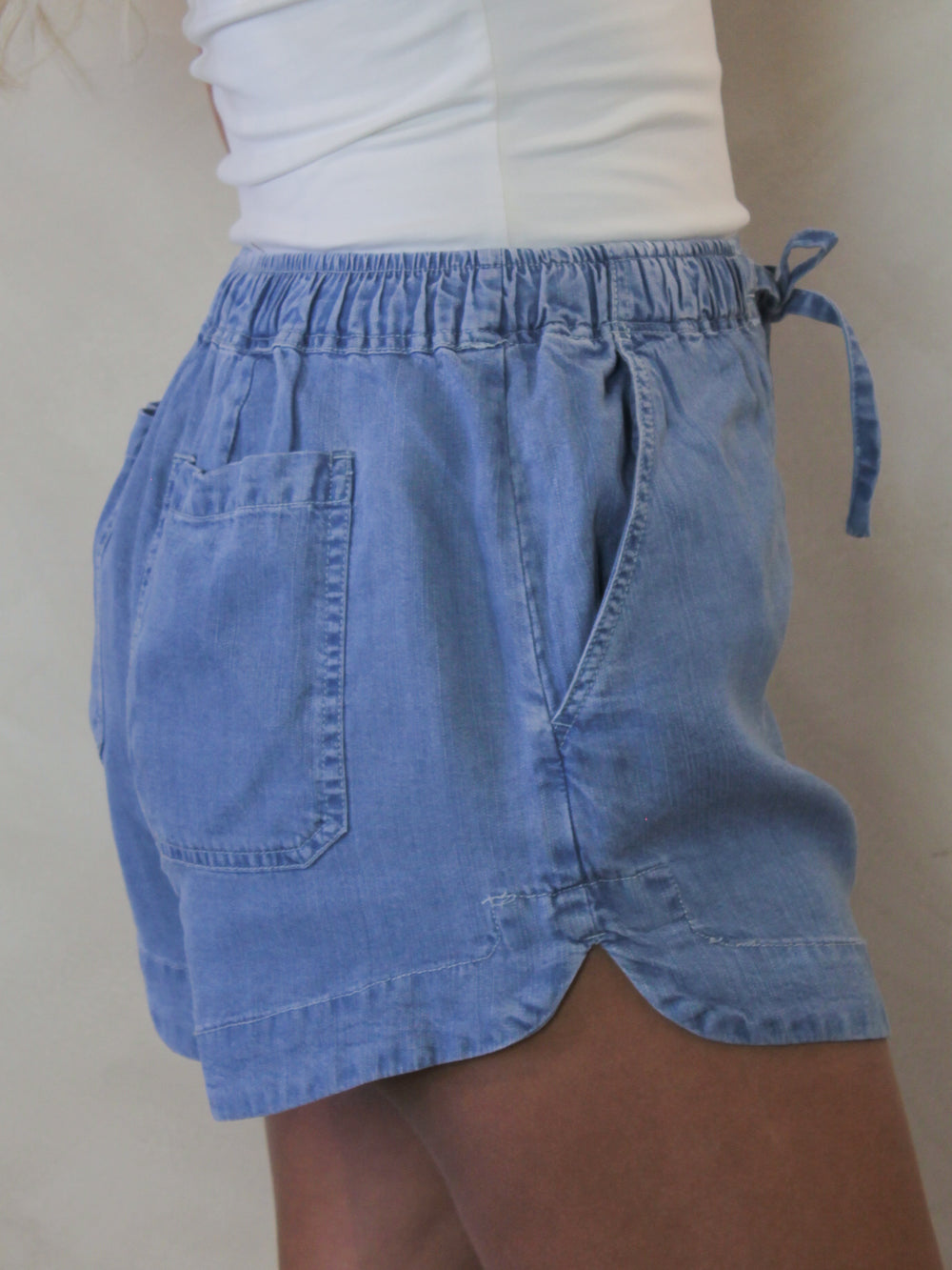 Side view of tencel denim shorts on a model 
