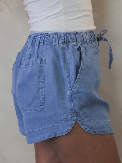 Side view of tencel denim shorts on a model 