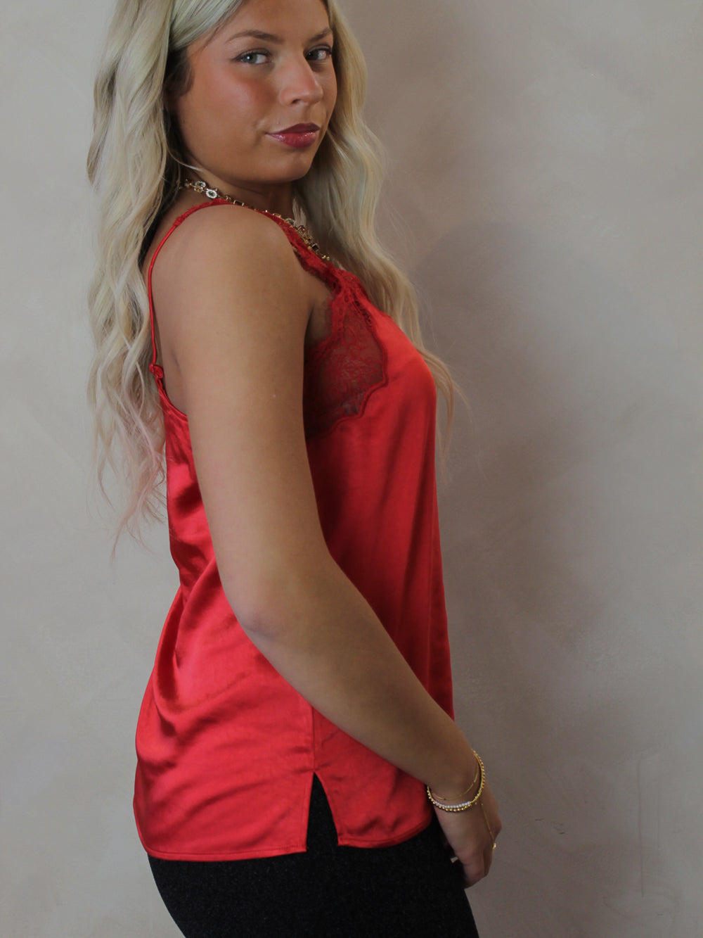 Model wearing a silky, satin, red lace tank 