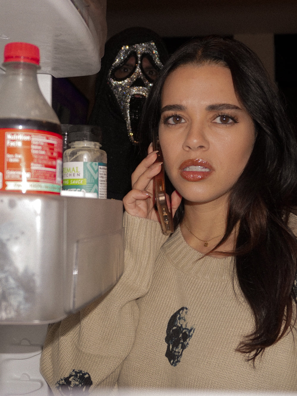 Girl wearing a skull print sweater modeling for a halloween shoot
