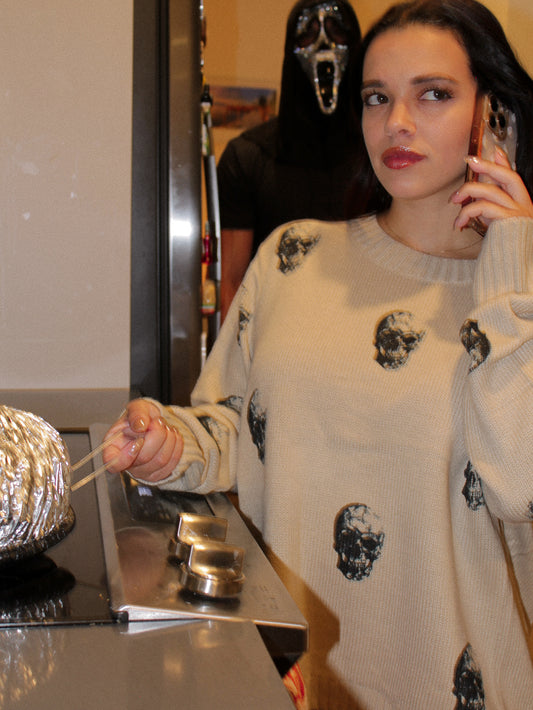 Woman wearing a beige skull print sweater