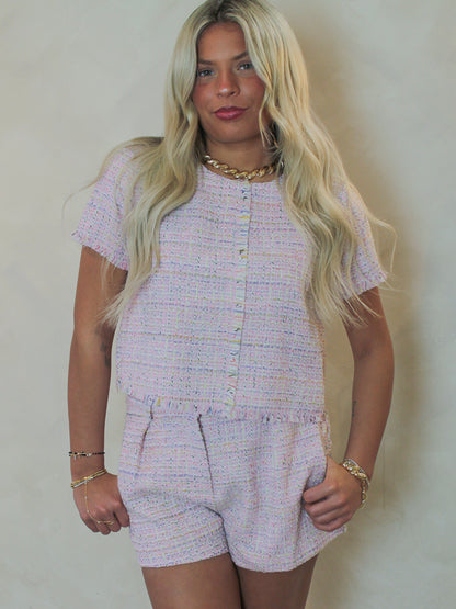 Model wearing a pink plaid tweed short set 