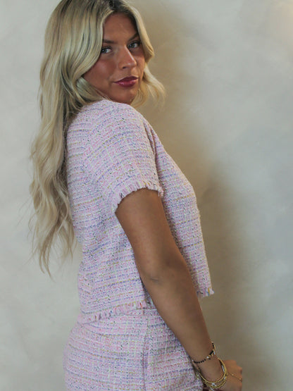 Side view of a pink short sleeve tweed top