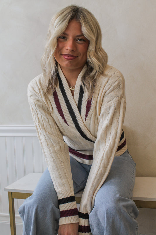 Woman wearing the Steve Madden Addison Sweater, a varsity cable knit 