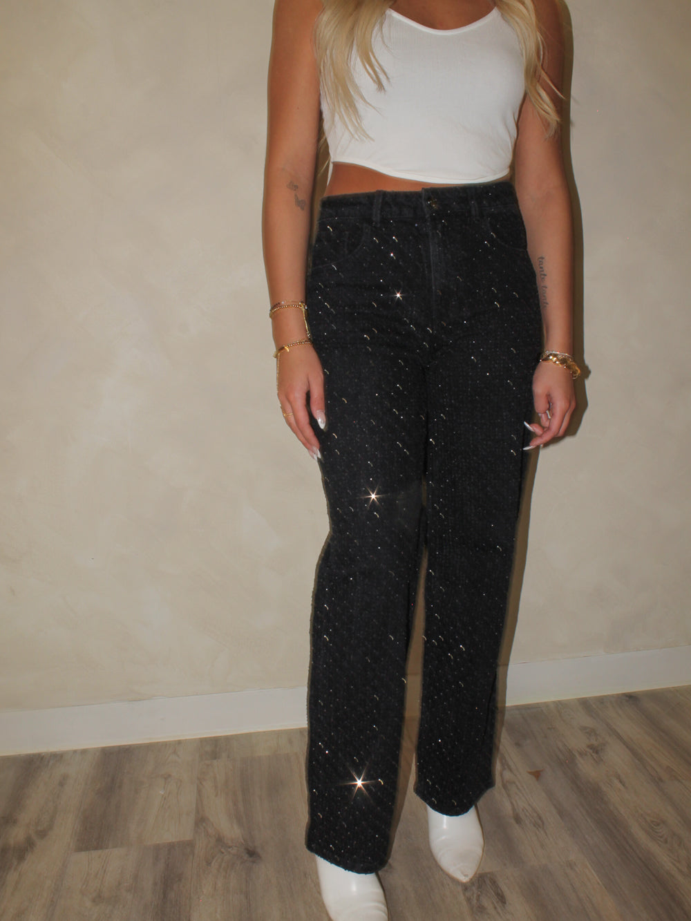 Model wearing black sparkly rhinestone jeans 
