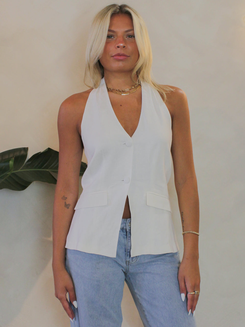 White Steve Madden Brielle vest featuring a deep v-neckline, button front and halter neckline