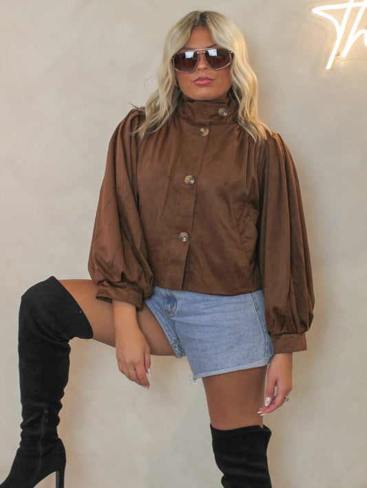 Woman wearing the Steve Madden Deirdra suede jacket with denim shorts and black boots 