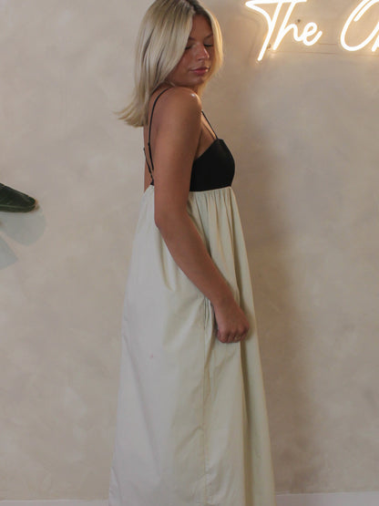 Side view of the Steve Madden Emmaline maxi dress with black bodice and flowy tan skirt.