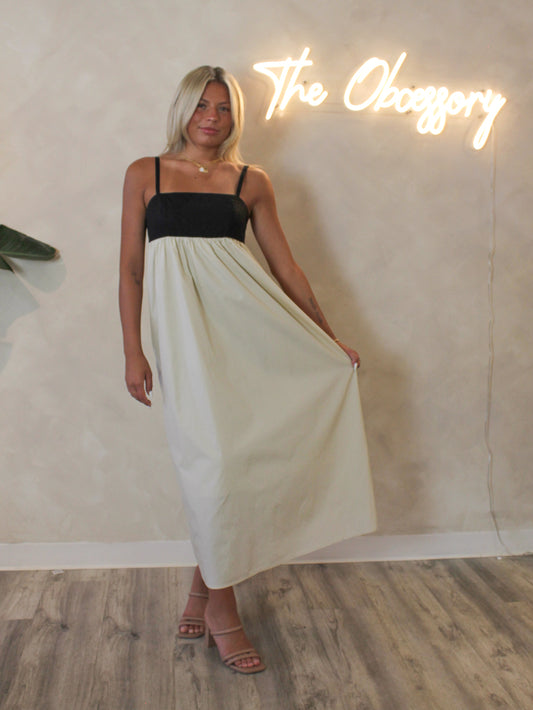 Model wearing the Steve Madden Emmaline black and tan maxi dress