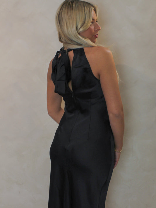 Detailed side view of a black halter neck satin dress for wedding guests 