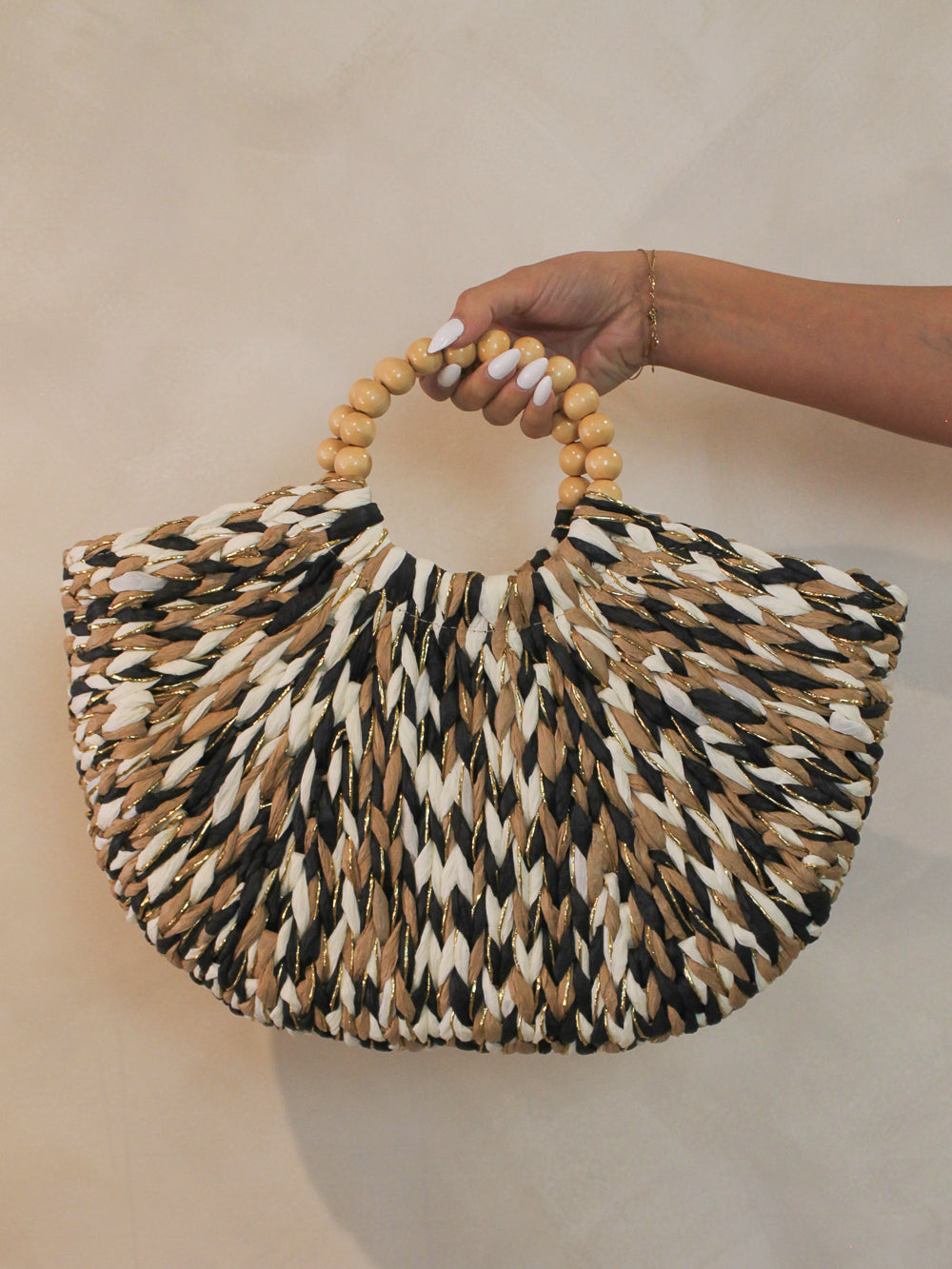Woven straw handbag with a beaded handle