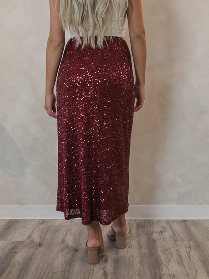 Model wearing a red sequin midi skirt for the holiday season 
