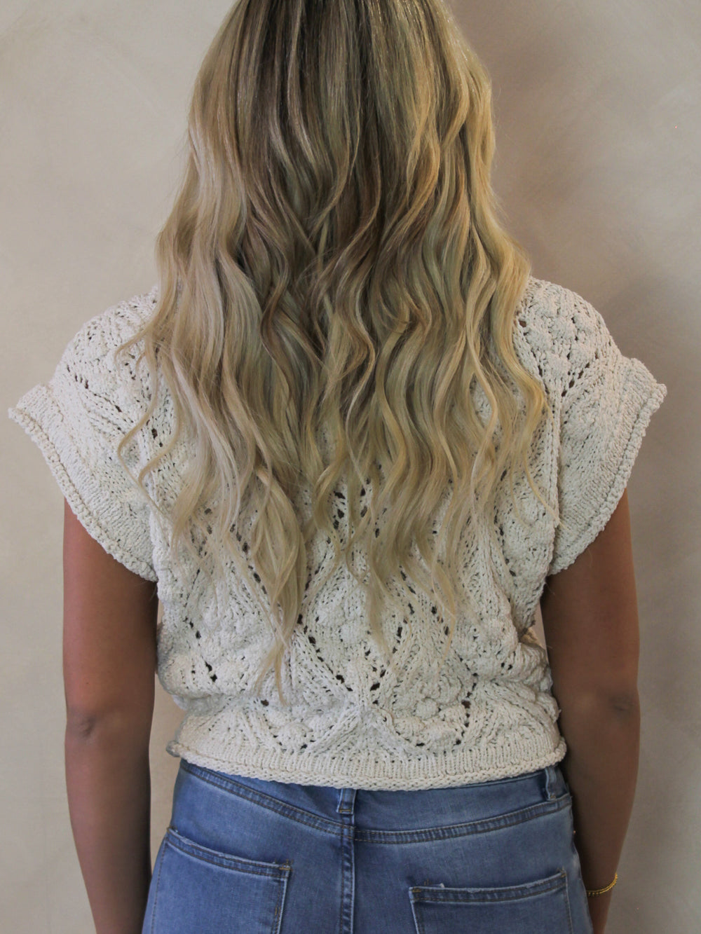 Model wearing a short sleeve crochet sweater