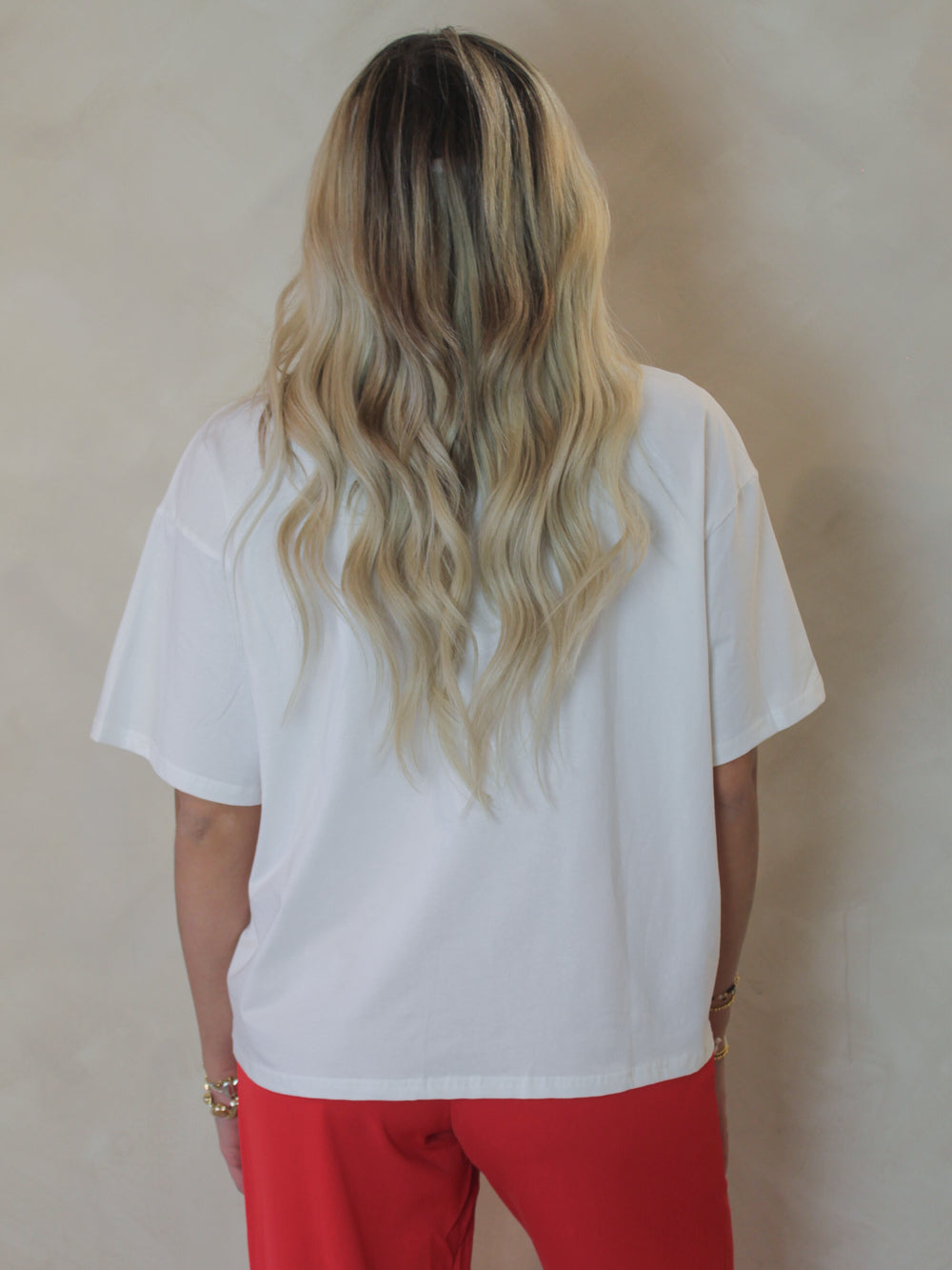 Model wearing a white boxy tee