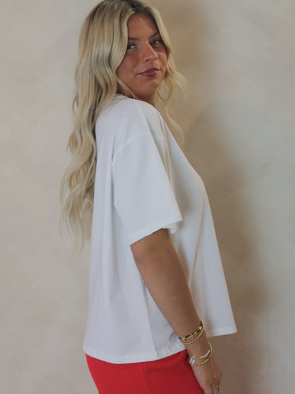 Model wearing a white, boxy t-shirt 