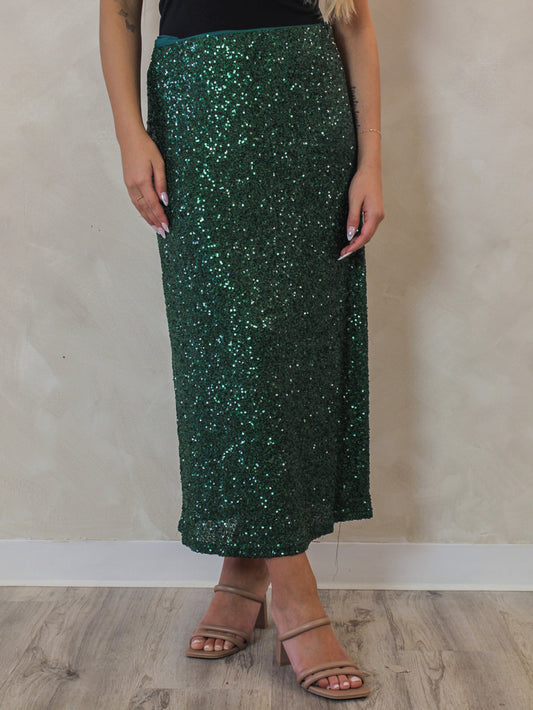 Woman wearing a sparkling green sequin skirt 