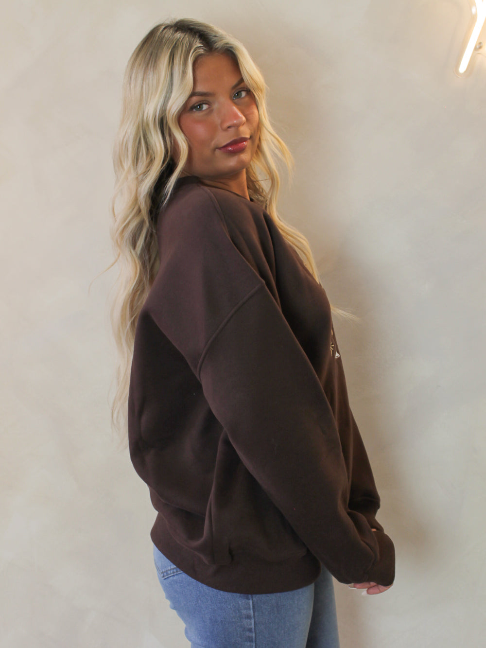 Woman wearing a brown oversized sweatshirt 