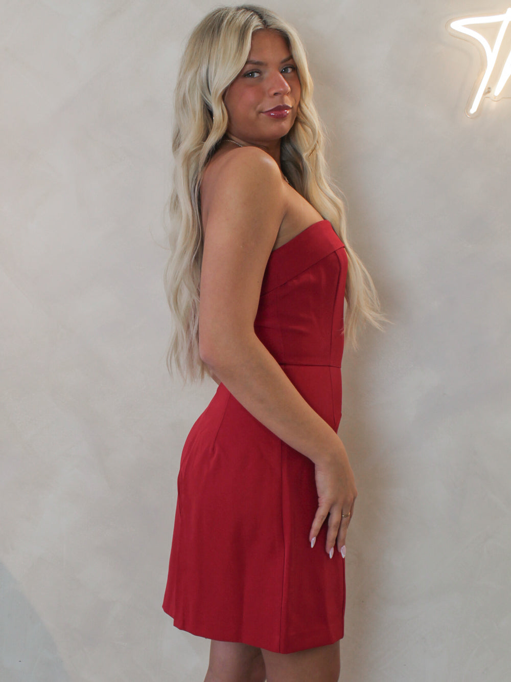Woman wearing a red strapless mini dress