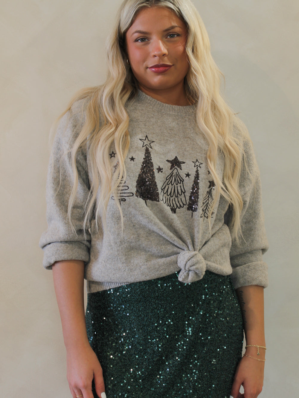 Grey Christmas sweater with sequin trees and styled with a sequin skirt 