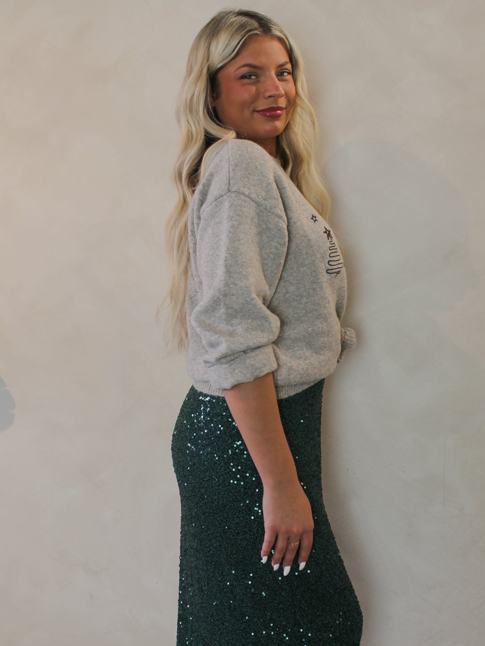 Model wearing a grey christmas tree sweater