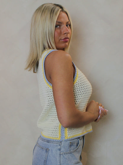 model wearing a butter yellow, spring, knit tank.
