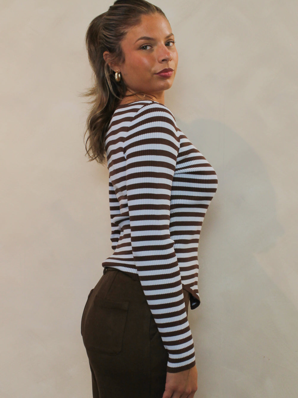 Side view of chocolate brown and blue striped top
