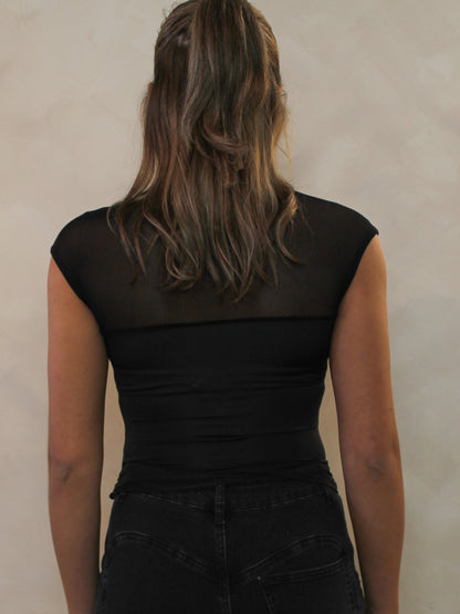 Back view of a black top with a mesh neckline