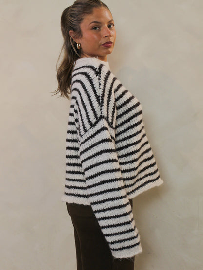 Side view of a white and chocolate brown striped sweater.