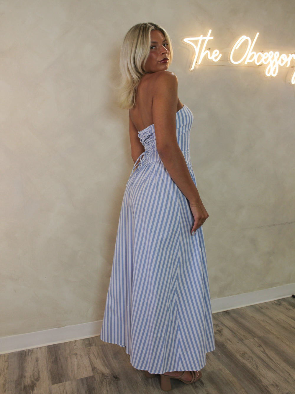 woman wearing a blue and white strapless maxi dress 