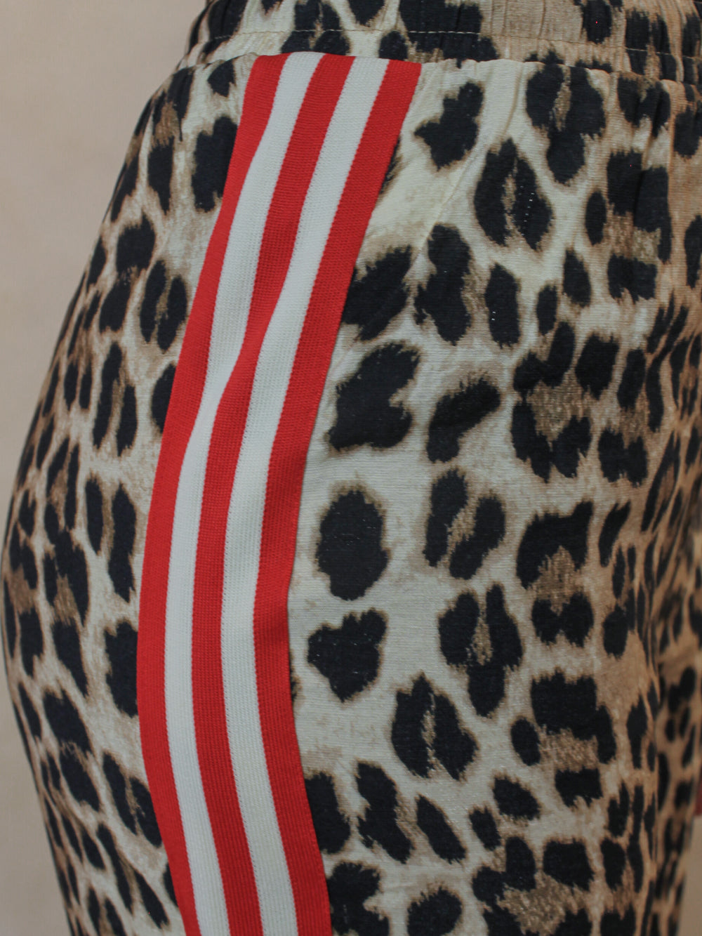 Leopard print wide leg pants with red and white stripe detail