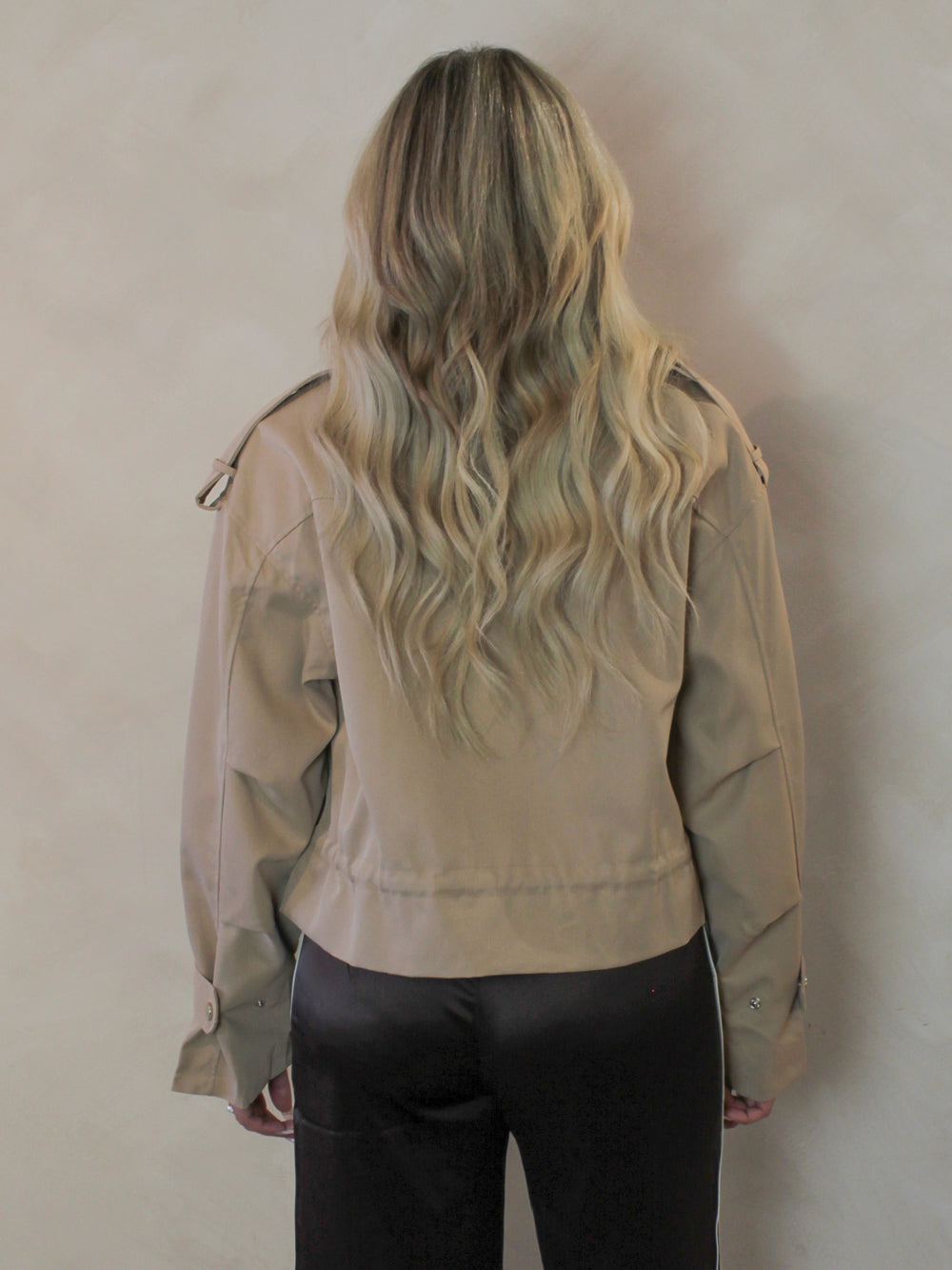 Tan cropped trench jacket for spring worn by a model 