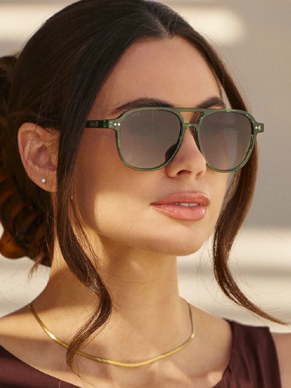 Woman wearing the green Hayden sunglasses with a smoke lens