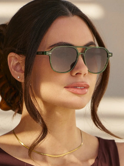 Woman wearing the green Hayden sunglasses with a smoke lens