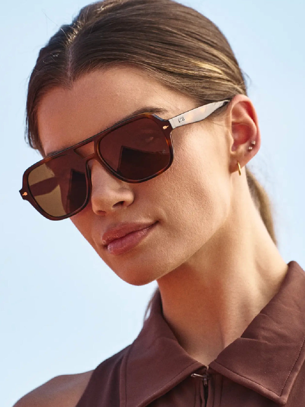 Woman wearing tortoise aviators with brown lenses