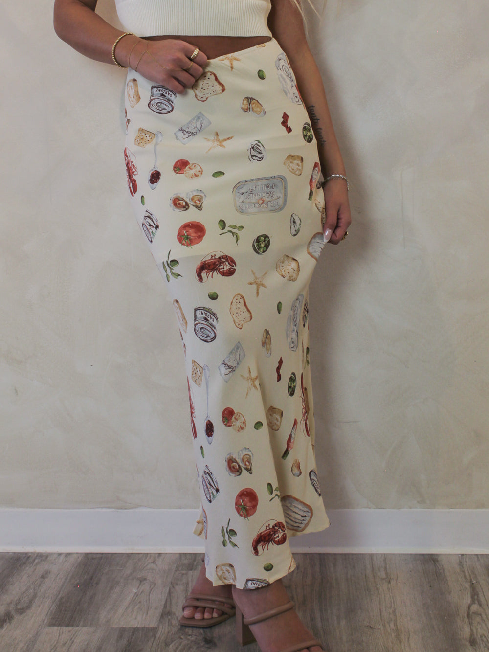 Model wearing a neutral coastal printed maxi skirt