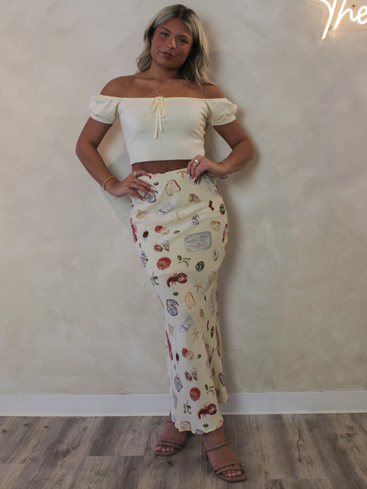 Model wearing a coastal print maxi skirt 