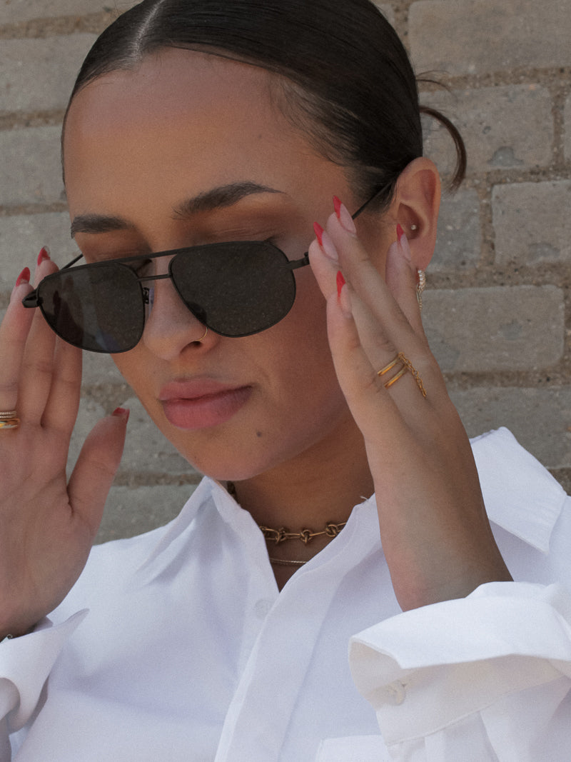 Girl wearing Black Framed Sunglasses and Gold Jewelry