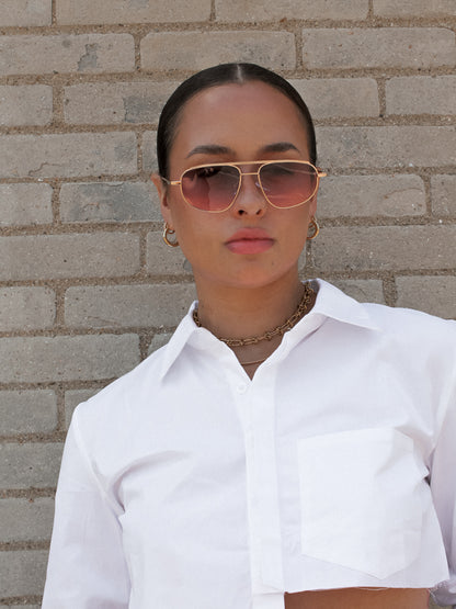 Girl wearing Gold Frame Sunglasses with Pink Lenses
